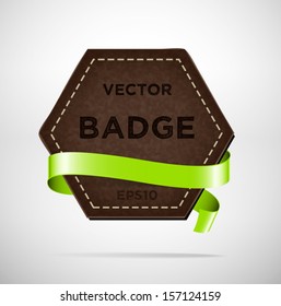 Vector vintage leather hexagonal badge with green silky ribbon