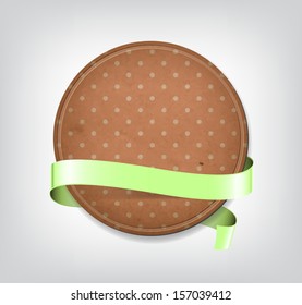 Vector vintage worn round old paper badge / banner with pink dotted pattern, with pale green silky ribbon