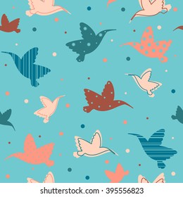 Vector wallpaper with colored birds on a blue background. Seamless pattern with cartoon hummingbirds. 