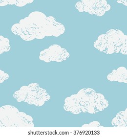 Vector weather background. Seamless pattern with cartoon clouds on blue sky. Grunge sponge effect 