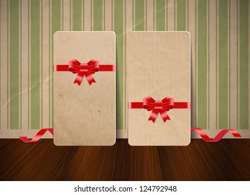 Vector white cardboard craft paper cards with festive silky ribbon bow knots over an old wall background with vintage wallpaper