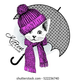 Vector white cat in a knitted cap and scarf with grey umbrella. Hand drawn illustration of dressed kitten.