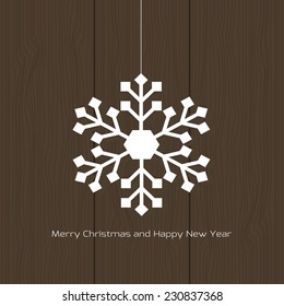 Vector white christmas snowflake on a wood background. Card