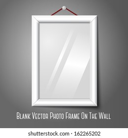 Vector white isolated vertical photo frame hanging on the wall, with glass.