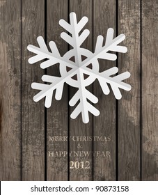 Vector white paper christmas snowflake on a wood background