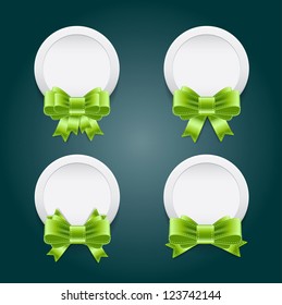 Vector white plastic round badges with green shiny satin ribbon bow knots