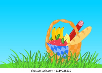 Vector wicker picnic basket with apples, bananas, baguette, sausage, cheese in green grass on blue sky background