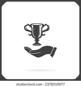 Vector winner cup on the hand Icon