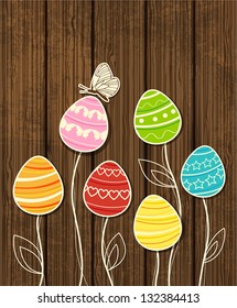 Vector wooden Easter background with decorative eggs and butterfly