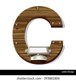 Vector wooden letter C with blank, white label in an old brass label holder filing cabinet drawer.