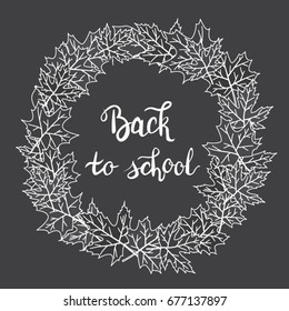 Vector wreath made of leaves. Handwritten lettering "Back to school".