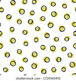Vector yellow and black polka dot hand drawn seamless pattern. Cute doodle repeatable motif on white background.