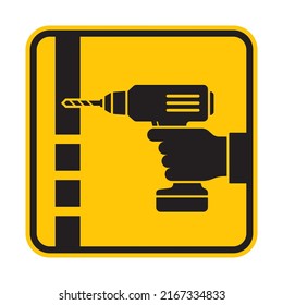 Vector yellow icon of a hand holding a drill drilling a hole. Isolated on white background.
