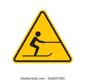 Vector yellow triangle sign - black silhouette figure skier pulled by a rope. Isolated on white background.