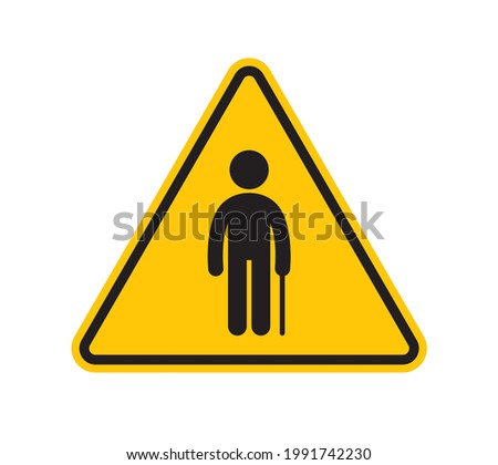 Vector yellow triangle sign - black silhouette figure of a pensioner with a crutch. Isolated on white background. 