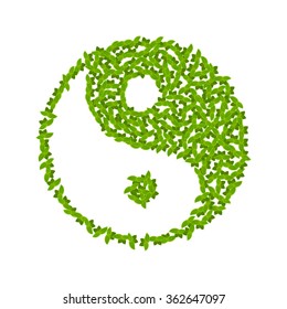 Vector Yin Yang symbol with green leaves.