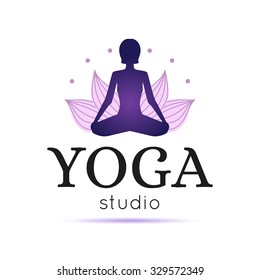 Vector yoga studio logo. Lotus yoga pose logo.Yoga maditation logo. Logo with a woman exercising yoga relaxation pose on a lotus background.