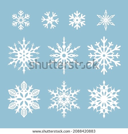 Vectors set of white snowflakes isolated on a blue background.