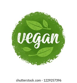 Vegan calligraphic handwriting lettering with leaf. Vector beige vintage illustration isolated on dark green circle sticker. Old paper background.