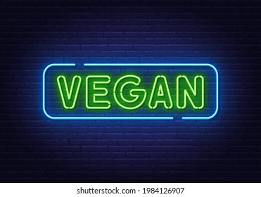 Vegan neon sign on brick wall background.