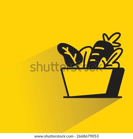 vegetable basket with shadow on yellow background