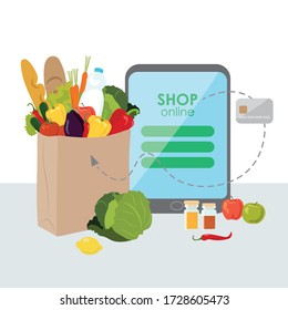 Vegetables in a paper bag. Online purchases in the store (gadget, tablet). Payment by Bank card. Cabbage, eggplant, tomatoes, carrots, cucumber, lemon, pepper, herbs, apples, bread, milk, baguette. 