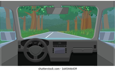 Vehicle dashboard view of a highway with trees