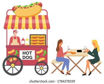 Vendor male standing with hotdog cart, fastfood retail. Women eating sausage and drinking coffee, urban marketplace with wheels, lunch outdoor vector