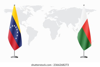 Venezuela and Madagascar flags for official meeting against background of world map.