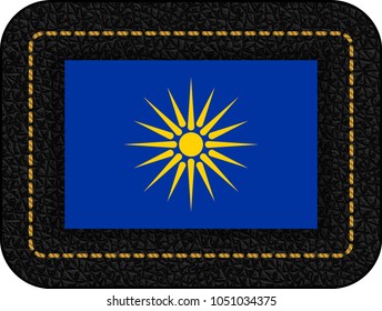 The Vergina Sun. Macedonian Flag Unofficial Version. Vector Icon on Black Leather Backdrop. Aspect Ratio 2:3