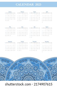 Vertical calendar for 2023 year with geometric pattern with blue mandalas. Week starts on sunday.