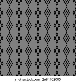 
​Columnas de Vertical repetidas de Formas de diamantes formadas por Pequeños motivos negros irregulares sobre un fondo gris sólido.
