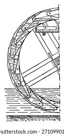 Vertical half-section of a fixed wheel-lifting buckets, vintage engraved illustration. Industrial encyclopedia E.-O. Lami - 1875. 