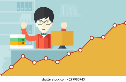 A very happy chinese businessman sitting while raising his both hand finished his work with laptop and paper works on time inside his office. Achievement concept. A Contemporary style with pastel