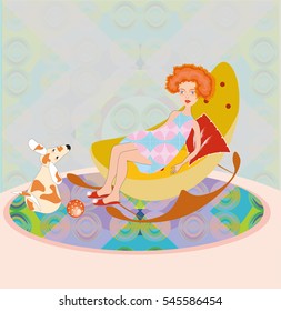 Very sweet and pretty red hair little girl sitting on a rocking chair with a small funny fox terrier dog playing ball in a nicely decorated room. 