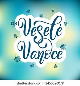 Vesele Vanoce on Czech language, phrase translate Merry Christmas. Happy winter holiday postcard with hand lettering holiday quote. Czech calligraphy on blur background with snow.