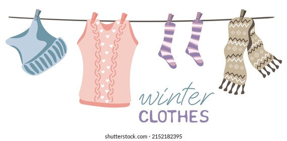 Vest, hat, scarf and socks hanging on the rope. Winter woolen clothes.  Hand-drawn vector illustration isolated on white background