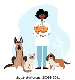 Veterinarian standing with cats and dogs on vet interior