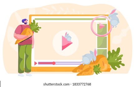 Veterinary blog, pet care, video tutorial about keeping and feeding rabbits at home, diet food for hares. Man pet owner holding a carrot watching video on the computer about meal for domestic animals