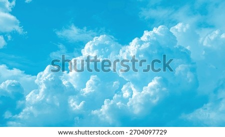 Vibrant blue sky with fluffy white cumulus clouds on a sunny day background