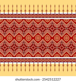 A vibrant and intricate textile design featuring a geometric motif with red, orange, and yellow elements. The design is created using a repeating arrangement of shapes and lines.