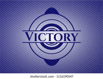 Victory badge with denim background