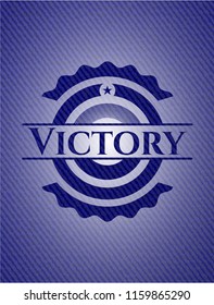 Victory badge with denim background