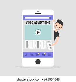 Video advertising on a mobile screen. Young character interested in an advertising. Tear-off ad. Flat editable vector illustration, clip art. Efficient ad format for millennials