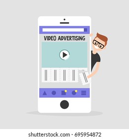 Video advertising on a mobile screen. Young teen character interested in an advertising. Tear-off ad. Flat editable vector illustration, clip art. Efficient ad format for millennials