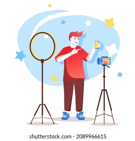 Video blogger flat character concept for web design. Happy man recording video review of mobile phone in studio, modern people scene. Vector illustration for social media promotional materials.