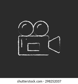 Video camera hand drawn in chalk on a blackboard vector white icon on a black background
