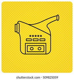 Video camera icon. Retro cinema sign. Linear icon on orange background. Vector