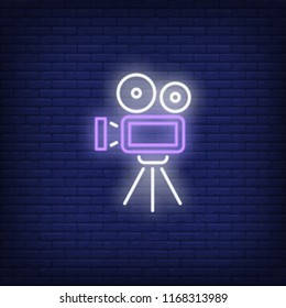 Video camera neon sign. Luminous signboard with retro film production equipment. Night bright advertisement. Vector illustration in neon style for vintage movie, filmmaking, videographer, creativity