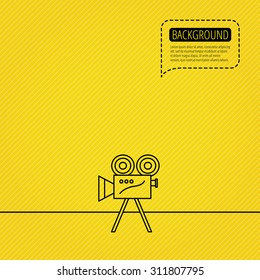 Video camera with reel icon. Retro cinema sign. Speech bubble of dotted line. Orange background. Vector